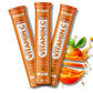 Three tubes of Gregus Vitamin C supplement with an orange and leaves on a white background